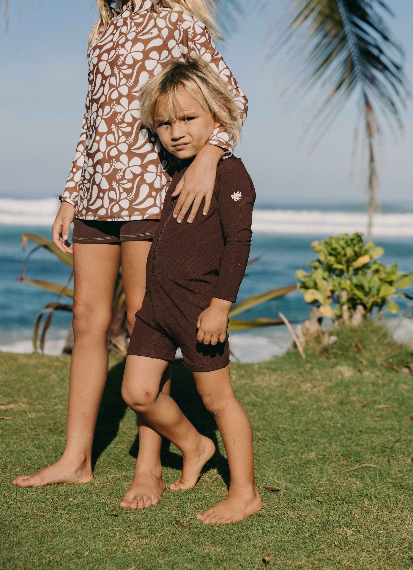 Introducing the Mini Dekker Surf suit, a long sleeve one-piece rash guard, with boy cut shortie bottom