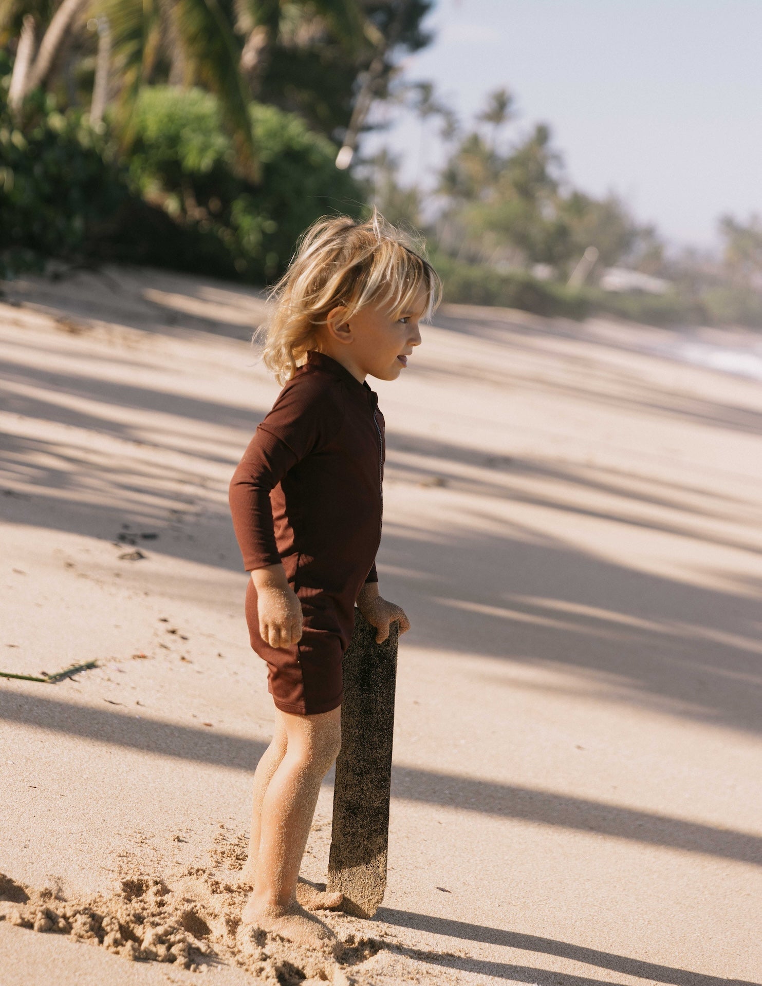 Introducing the Mini Dekker Surf suit, a long sleeve one-piece rash guard, with boy cut shortie bottom