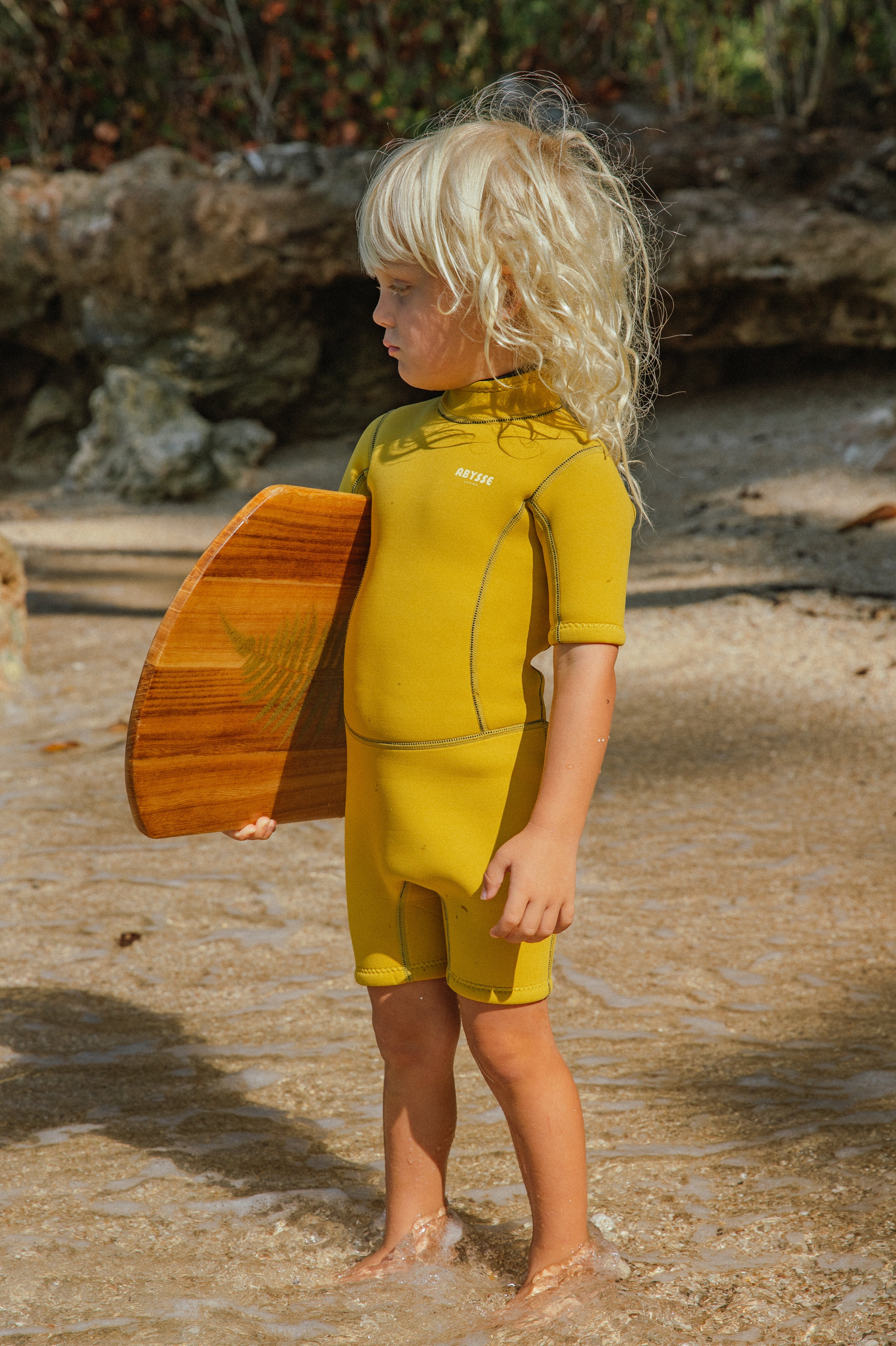 kid in a sustainable wetsuit